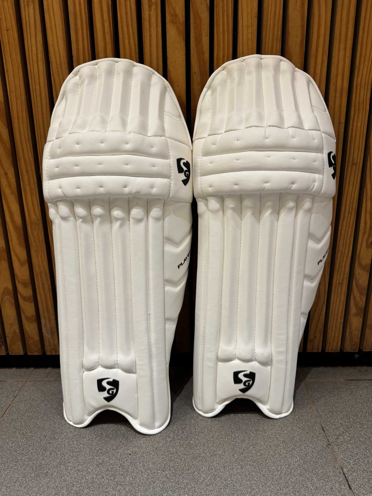 Pair of SG Players men's right-hand batting leg guards in white